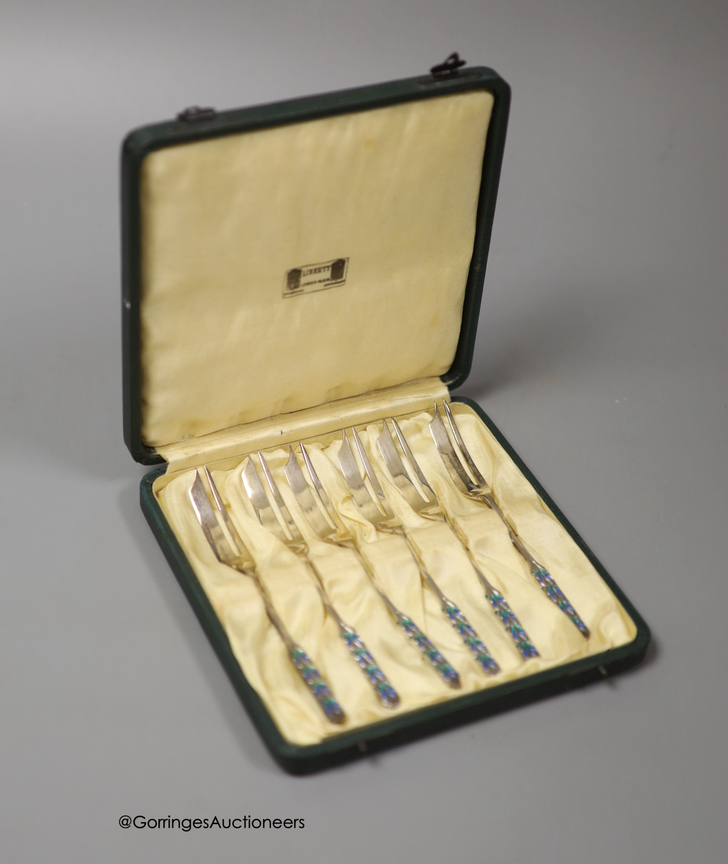 A cased set of George V Liberty & Co silver and enamel pastry forks, Birmingham, 1928, in original Liberty & Co box